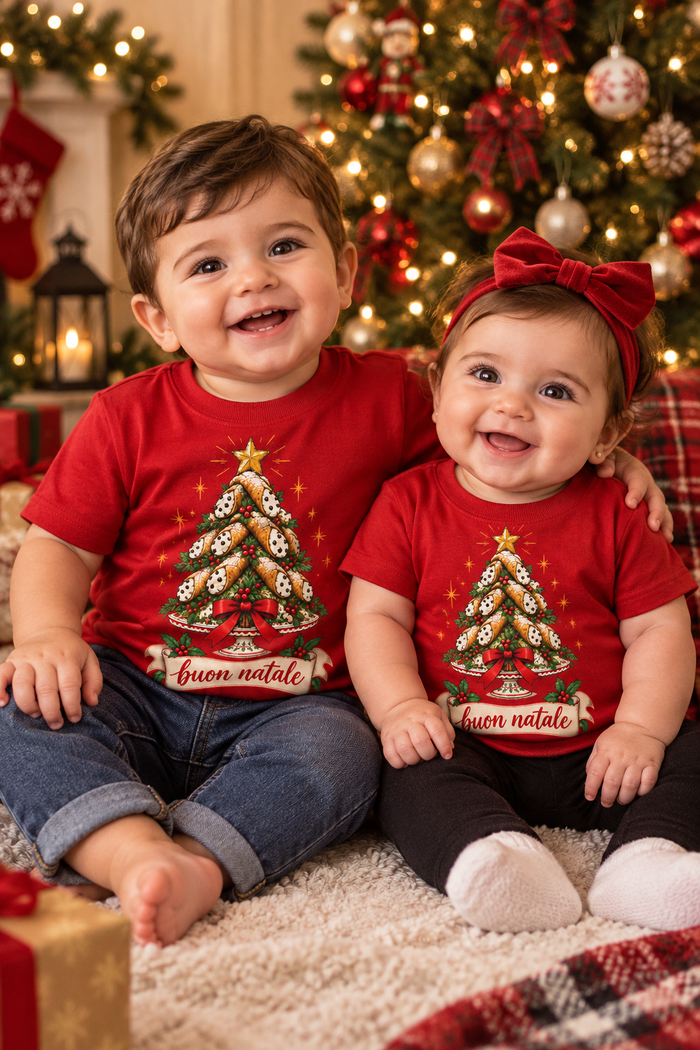 1-year-old boy and 6-month-old girl in Cannoli Tree Buon Natale shirts by the Christmas tree