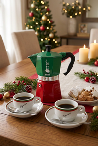 Bialetti coffee pot and espresso cups with Christmas cookies in a festive dining room