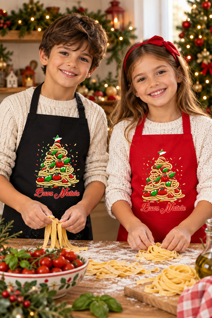 Boy and girl wearing black and red Buon Natale Pasta aprons in a Christmas kitchen