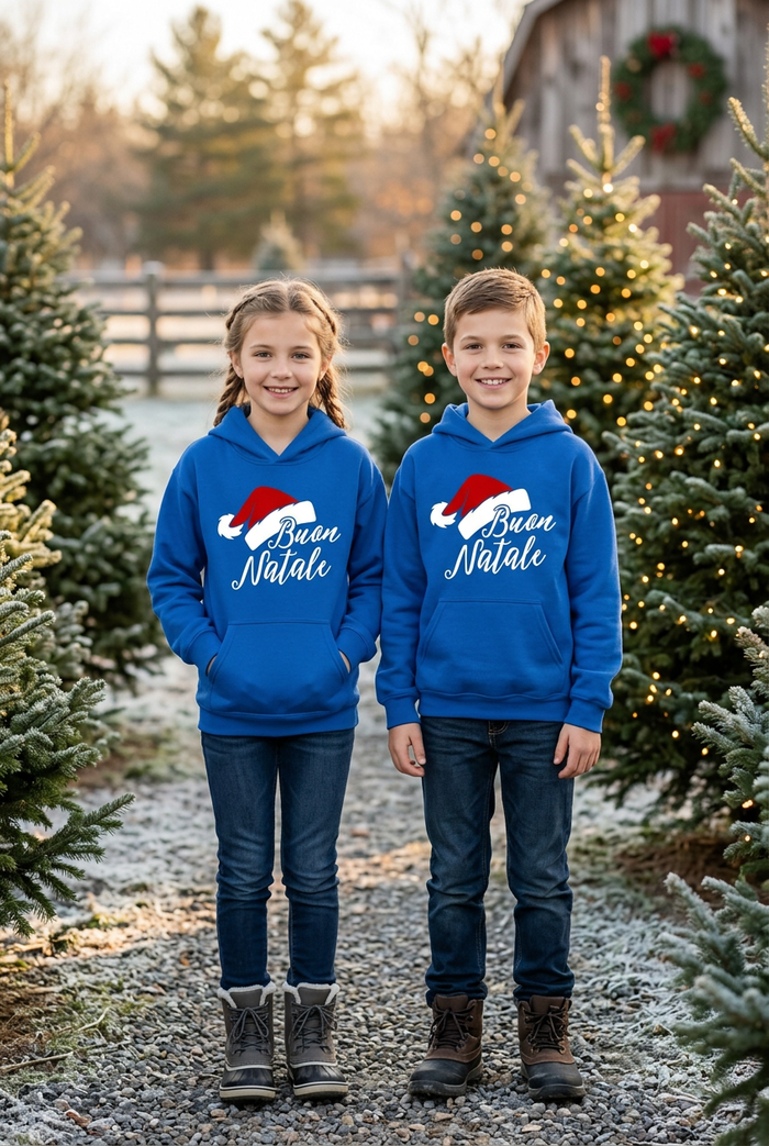 Boy and girl wearing blue Buon Natale hoodies outdoors at Christmas