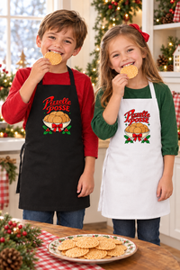 Boy and girl wearing Pizzelle Posse aprons and enjoying pizzelle at Christmas
