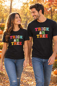 Couple walking in black Trick or Tree T-shirts in an autumn setting