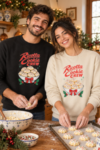 Italian couple in black and sand Ricotta Cookie Crew sweatshirts in a kitchen