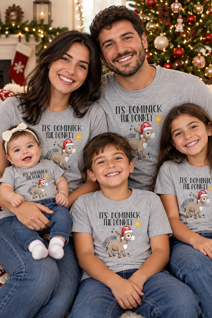 Italian family of four in matching gray Dominick the Donkey shirts by the Christmas tree
