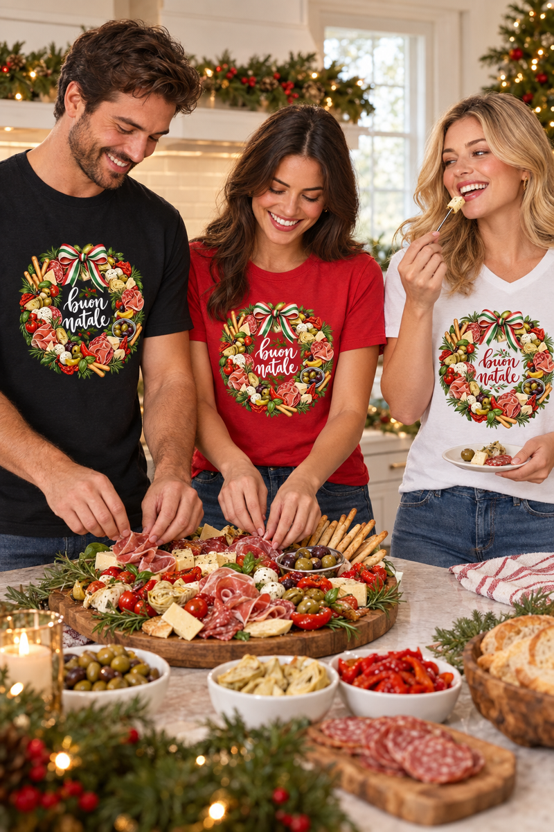 Man in black and woman in red preparing antipasto while a woman in white enjoys a bite, all wearing Buon Natale Antipasto tees