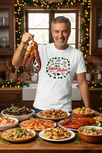 Man in the new white Seven Fishes shirt holding up an octopus in a Christmas Italian kitchen
