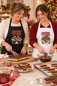 Mother and daughter making rainbow cookies in matching Christmas aprons