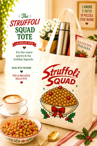 A cream canvas tote bag printed with 'Struffoli Squad' in red script and an illustration of stuffed pasta in a bowl, styled with a thermos, book, and plants on a table. The bag is surrounded by coffee, pasta, and holiday decorations, with Italian text overlays on the left.