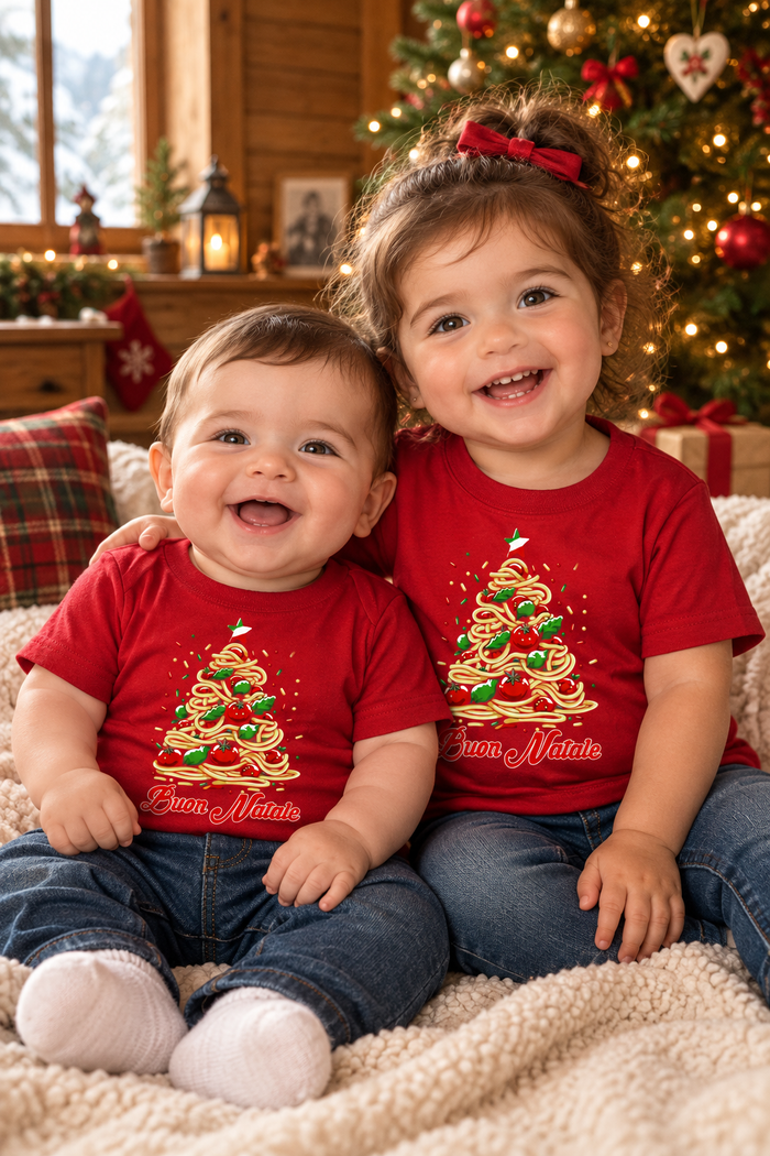 Two Italian babies wearing the Buon Natale Pasta shirt by a Christmas tree